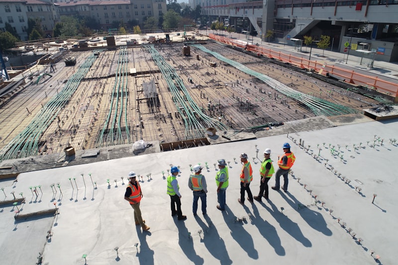 Construction workers coordinating subcontractor and trade services